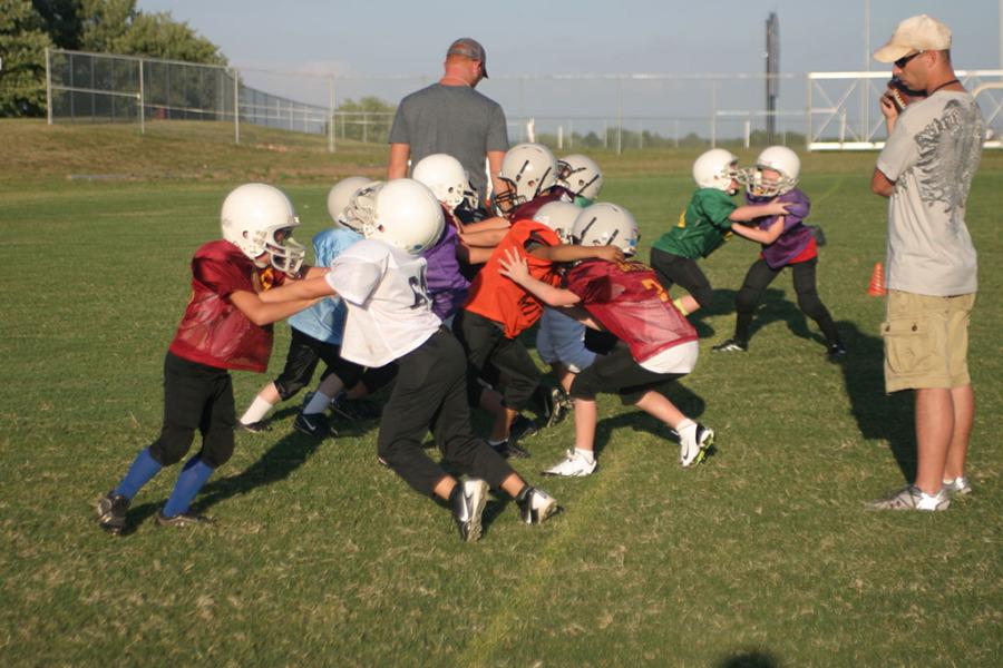 Young Mighty Mites team practices their blocking skills.