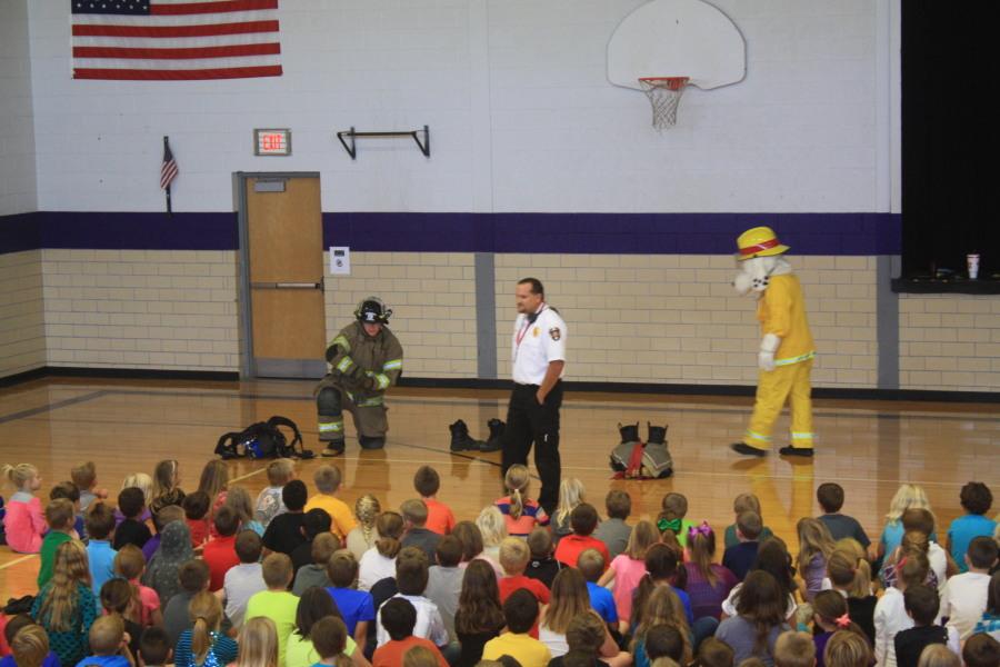 Elementary students listen to the Fair Grove Fire Chief and his helpers discuss fire safety.