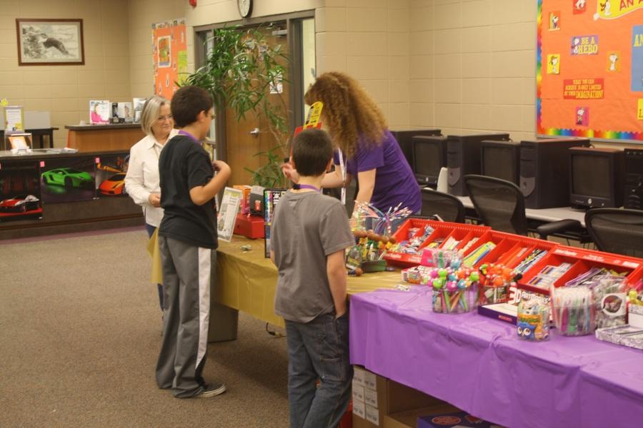 Mrs. Lemon helps students find books in the Library during the Book Fair.