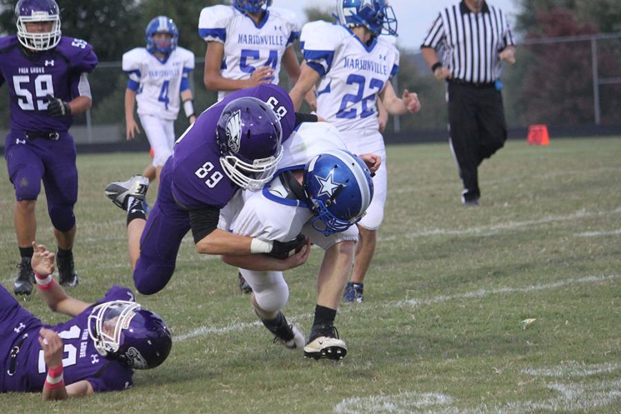 Freshmen Matt Emert makes a tackle on a Marionville player. 