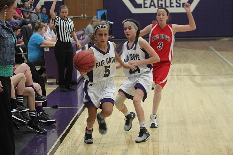 8th grader, Maddie Clark, dribbles the ball down court.