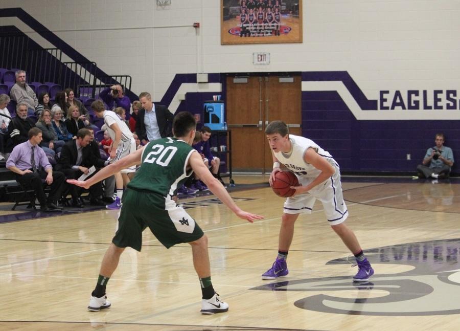 Garrett Kesterson holds the ball at the three point line.