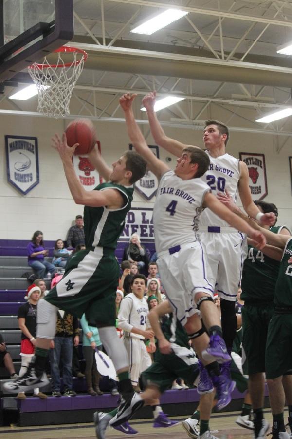 Zane McCurry (12) and Evan Fullerton (10) jump to block a shot against Mount Vernon.