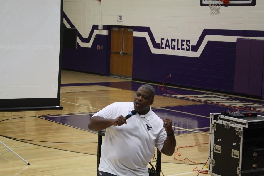 Professional football player Steve Grant speaks to students during the assembly. 
