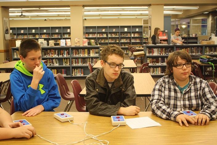 Middle sGrant chool students Nate Squires, Nate Brigman,  and Nate Bruner practice buzzing in to answer questions for  the Middle School Scholar Bowl Tournament.