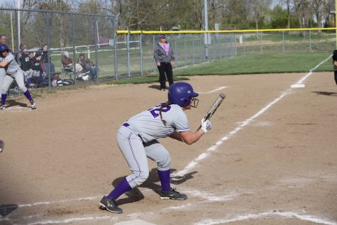 Beckley coaches first base, while Jordan Coddington squares to bunt.