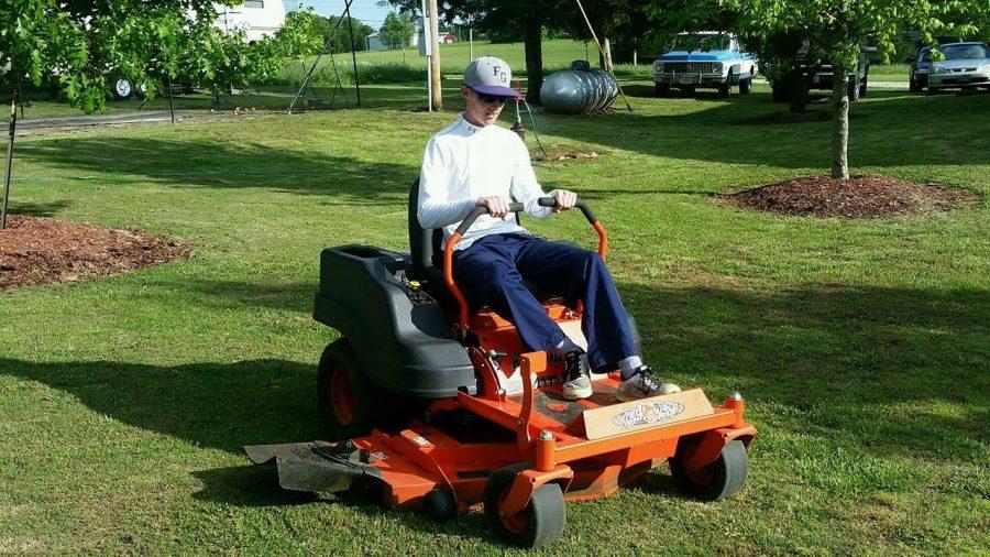 Ryan Burks  mowing lawns for his summer job
