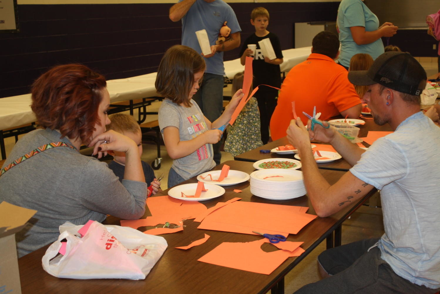 Elementary students enjoy arts and crafts with their grandparents