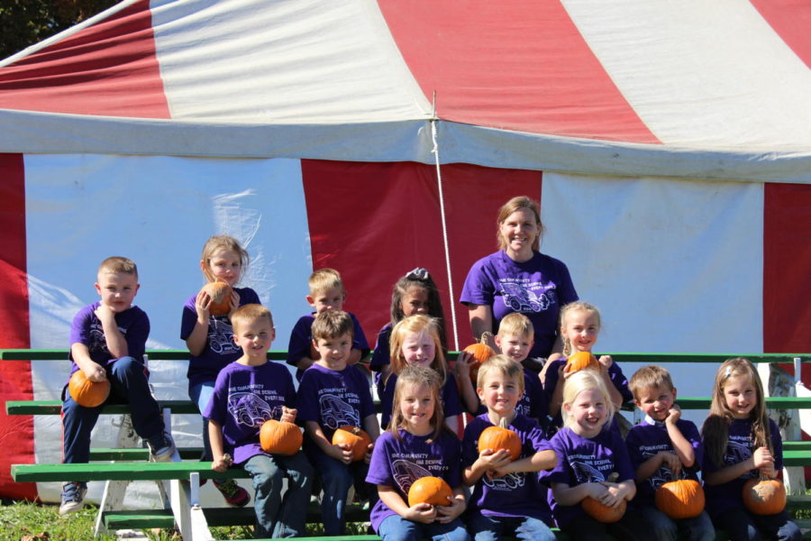 Fair+Grove+elementary+students+pose+with+their+pumpkins.