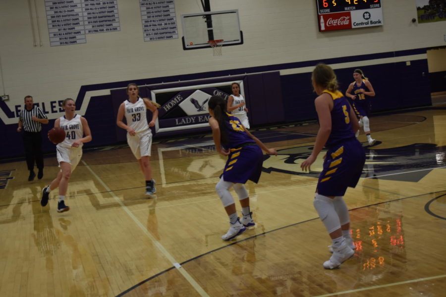 Alana Findley(11) dribbles the ball down the court.