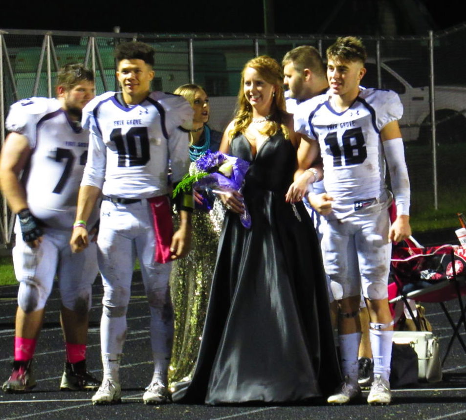 Homecoming Queen Kalyn Wheat and her escorts, Seniors Elijah Young and Cayden Stacey, wait to be announced.