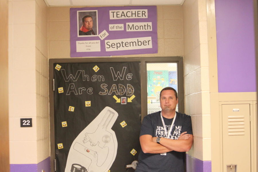 Mr. Foster poses in front of his decorated door