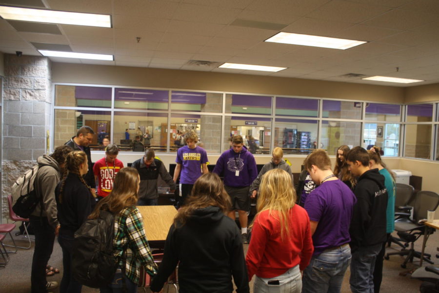 Students pray during a morning JOLT meeting