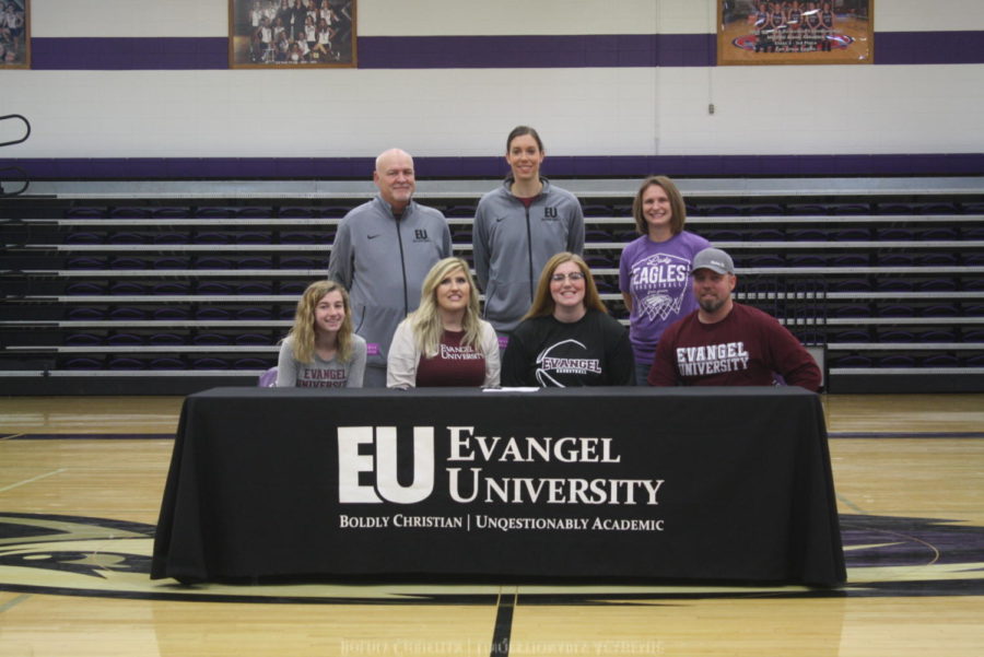 Harley Maxwell (12) poses with her family and Evangel basketball coaches