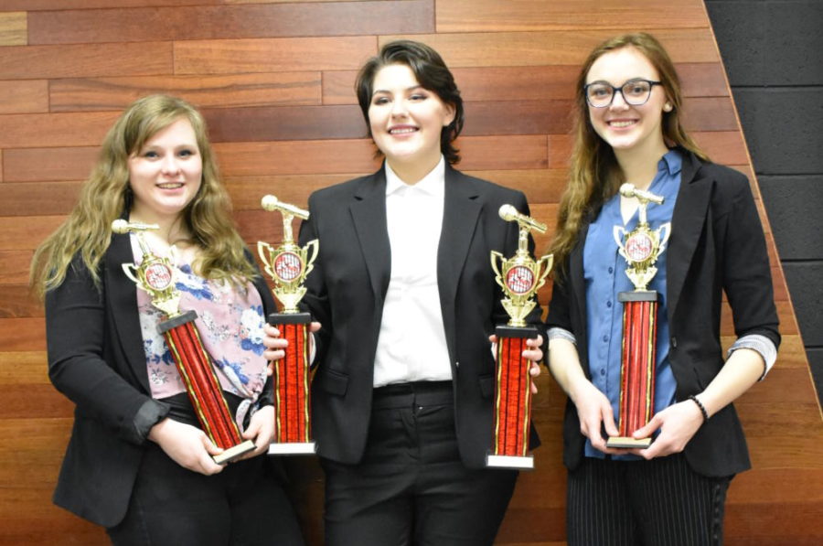 Emma Hackett (12) , Georgia Whalley (11) , and Kayla Hodges (12) pose with their trophies