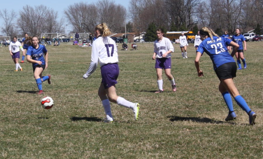 Gracie Rowden [12] dribbles the ball down the field.