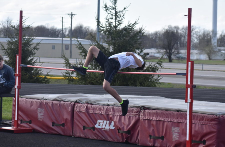 A Middle School track member participates in high jump.
