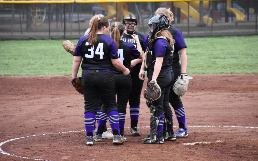 The softball team comes in for a huddle.