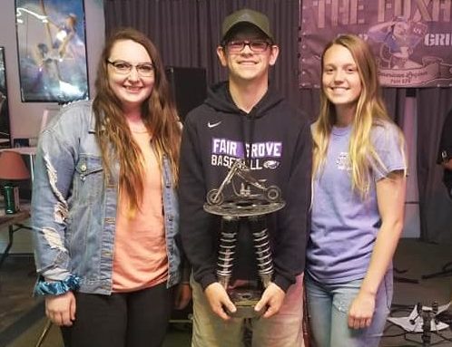 2019 seniors Taylor Brumage, Dylan Mooneyham, and Kelly Meismer posing with car show fundraiser trophy