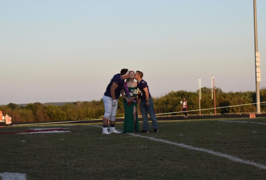 Homecoming queen, Heather Mcdougal walked by football players, Cody Jeter, and Gaven Peterie