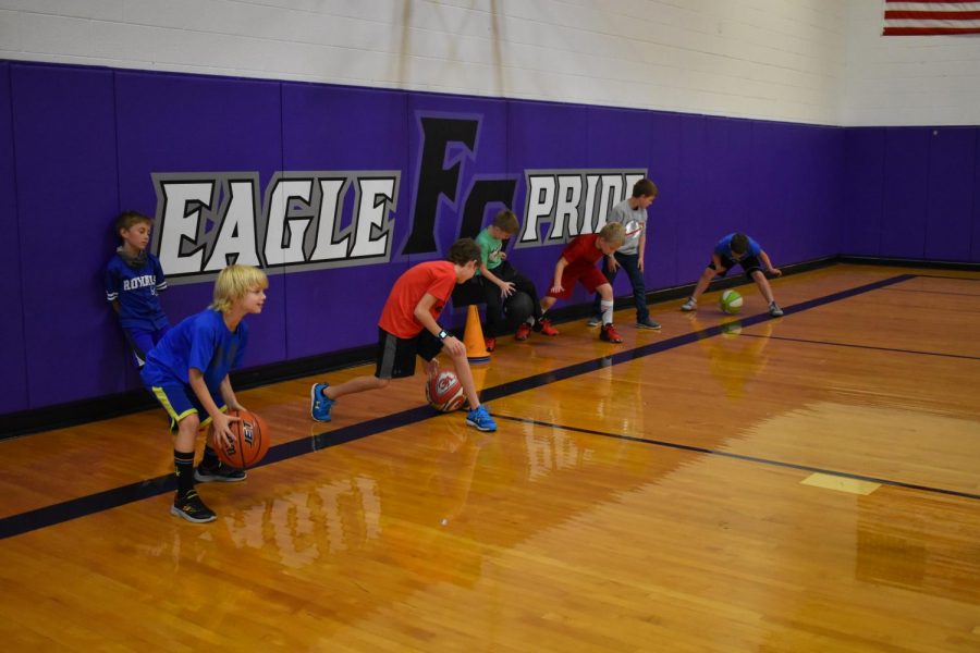 Young kids practiced their dribbling in basketball camp in the Upper Elementary gym.