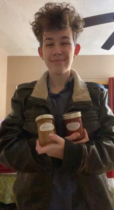 Helen Huffman (12) posing with two jars of homemade jam.