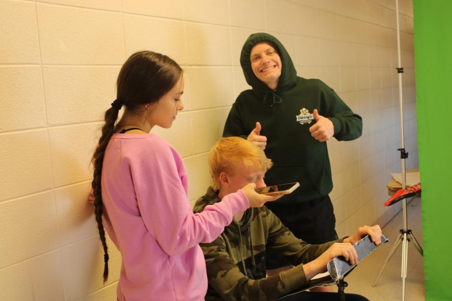 Ryken Adkins (12), Andrew Faubion (12), and Savanna Luna (11) filming a video for their Digi-Comm segment. 
