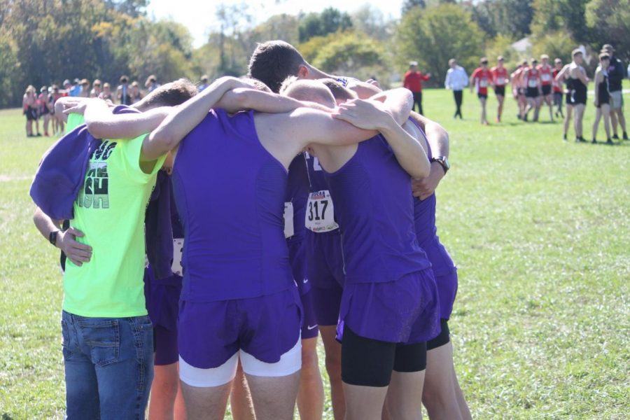 The Cross Country team in a huddle before the race at Clever High School.