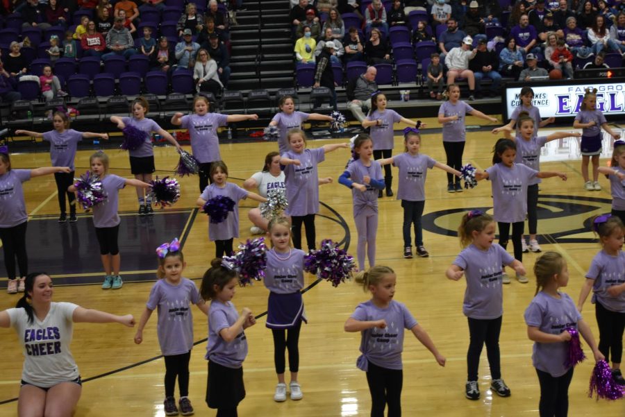 High school cheerleaders assisting the performance of the elementary cheer camp performance at a boys basketball game on 1/14/22.