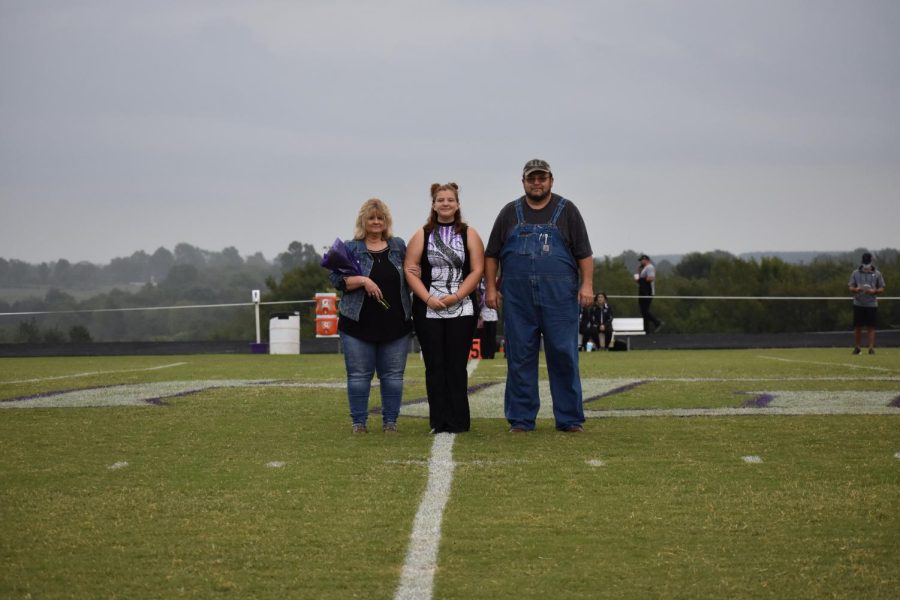 Dory Baker with her parents Bill and Denna Baker on band senior night 2020.
