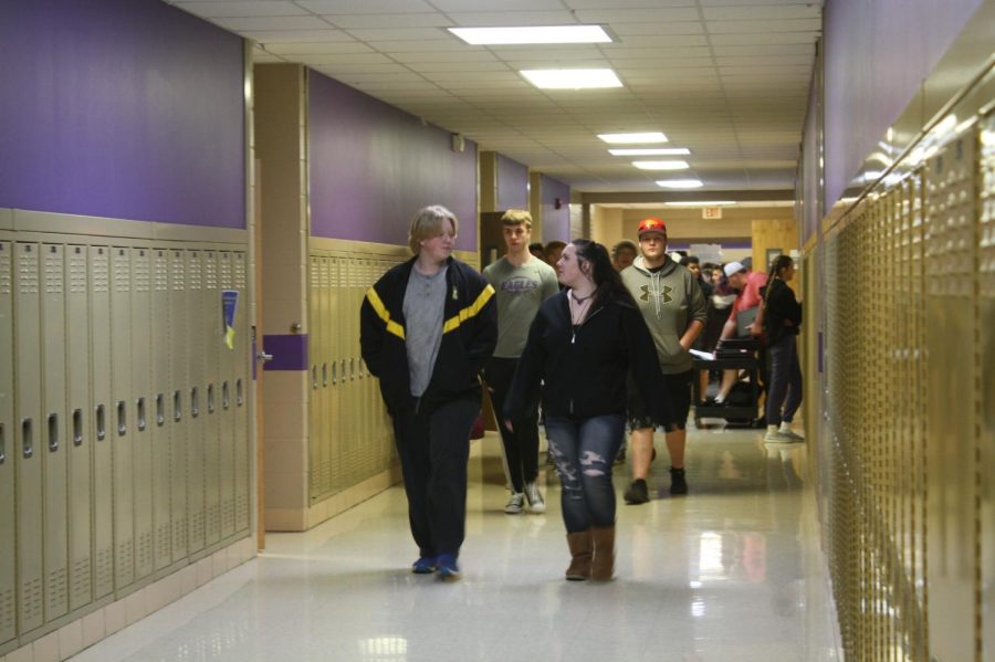 Students Triston Louthan and Kaylee Nicole walking through the halls of Fair Grove High School.