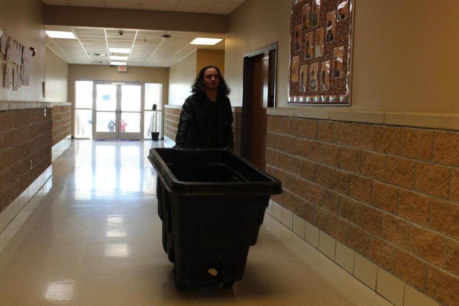 Matt Cockroft, student janitor, taking out the trash. 
