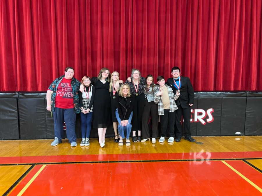 From left to right, Aidyn Owings (8), Jasper Boone (8), Katelyn Borslien, (8), Alyssa Faubion (8), Amy Holland, Mackenzie Jenkins (8), Ryanne Crutcher (7), Preston Hicks (8) and Keith Nolan (8) at the Ozark Middle School Speech and Debate Tournament on April 9th, 2022. Photo provided by Cooper Zumwalt.