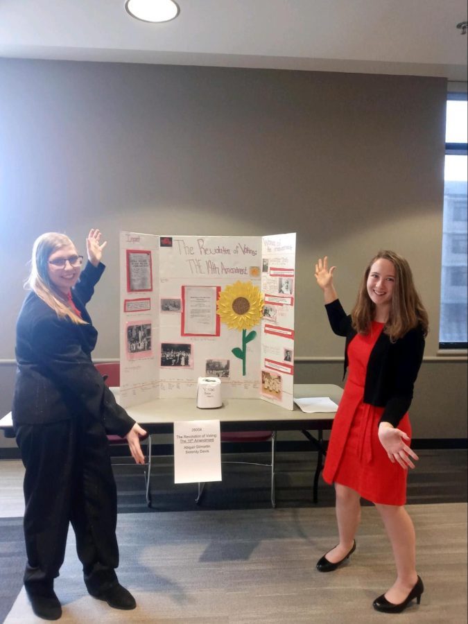 Serenity Davis (left) and Abigail Gilmartin (right) presenting the poster they made for National History Day.