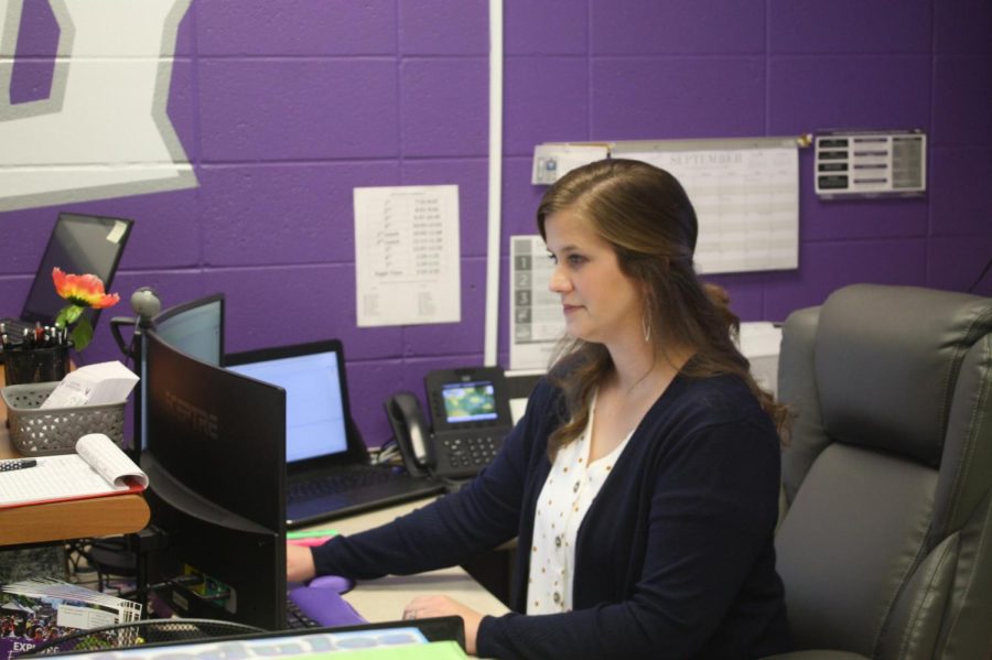 High School secretary Trilby Workman working on her computer.