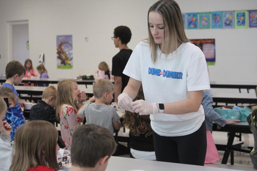 A+ Student helper, RayAnn Hupman, helping elementary students at lunch time.