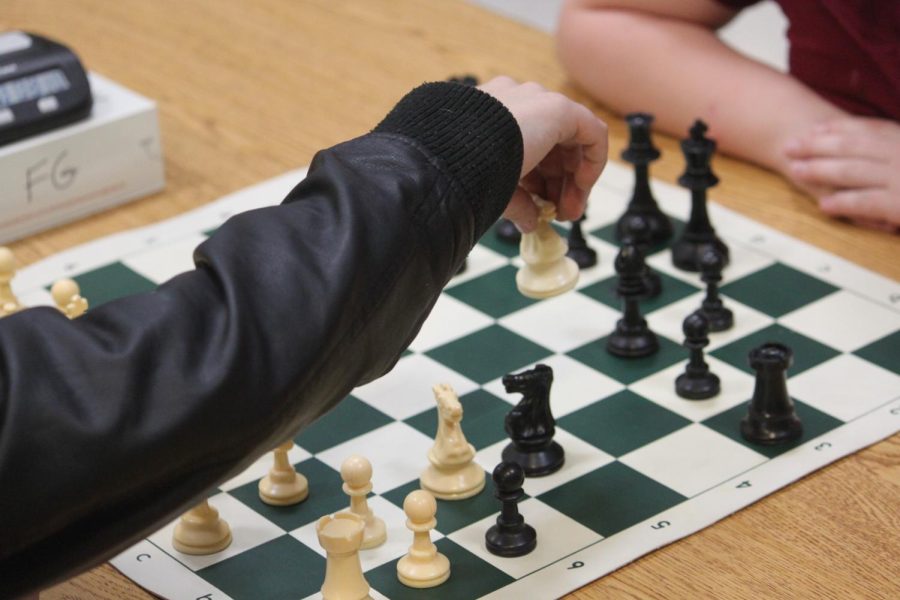 Silas Bowman (5) playing chess against Elyana Andrews (5). (photo taken by Kris Hunter)