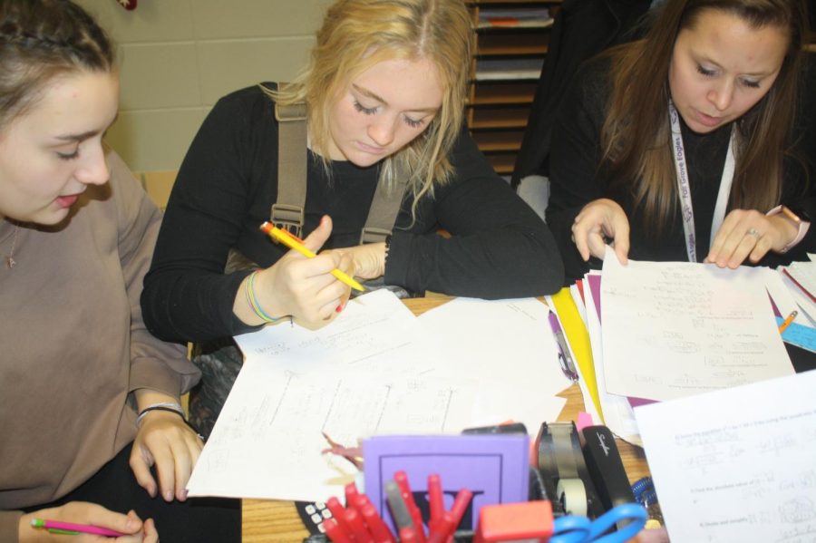 Alyssa Snitker and Olivia Brumfield working with Mrs. Kisling during Pizza and Planning 12/14. (Photo taken by Ivy Wehmeyer)