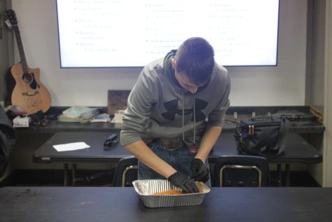 Braden Booth preparing meat during his agriculture class. (photo taken by  Mattilee Wilson)