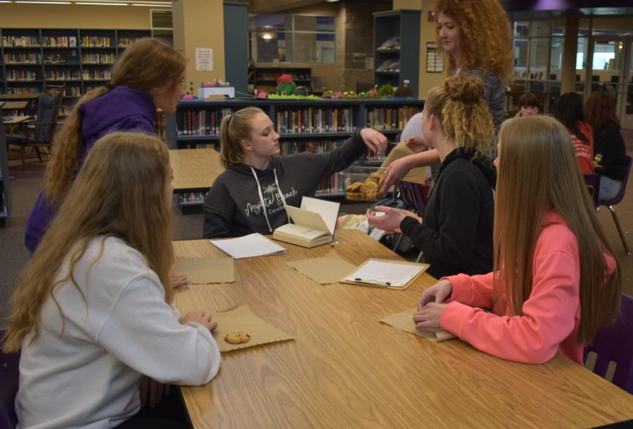 Mrs. Lemon handing out cookies at Book Club (left: Carley Lepold). (photo taken by Ivy Wehmeyer)
