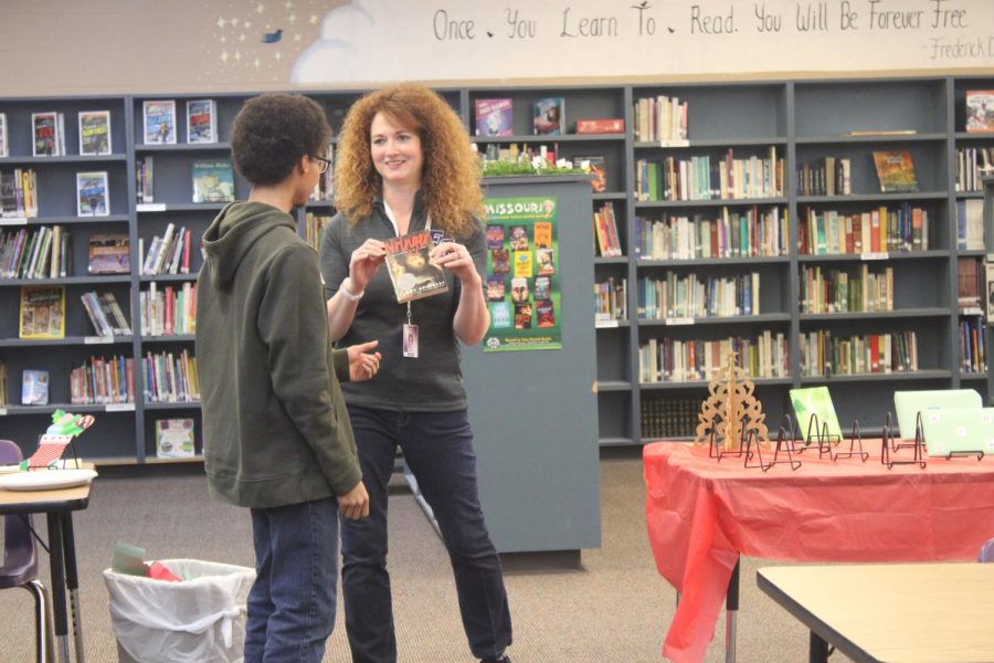 Mrs. Lemon sharing a book with Jaden Hudson (12). (photo taken by Ivy Wehmeyer)
