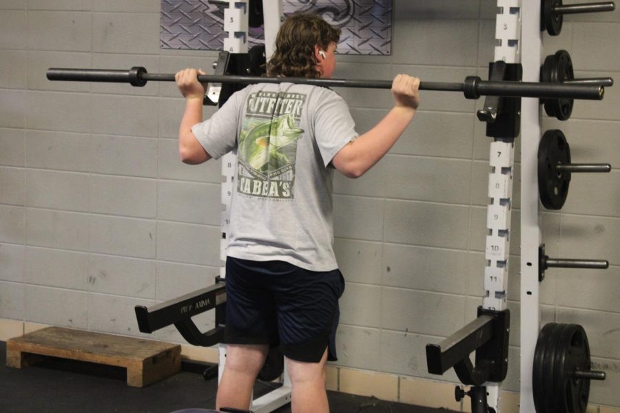 Tony Lassley squatting at off-season weights. (photo taken by Sawyer Haskins)