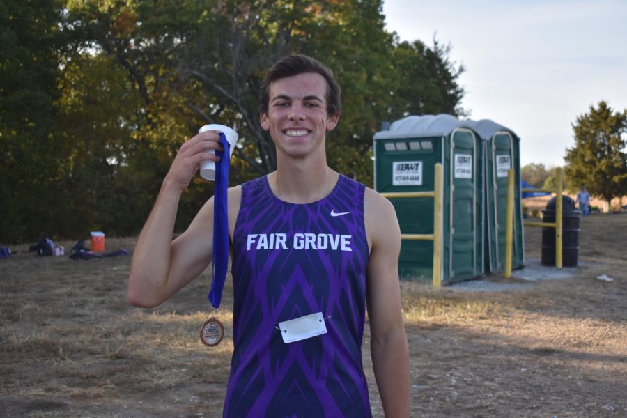 Garin Geitz receiving his medal after a cross country meet.
(photo taken by Sawyer Haskins)