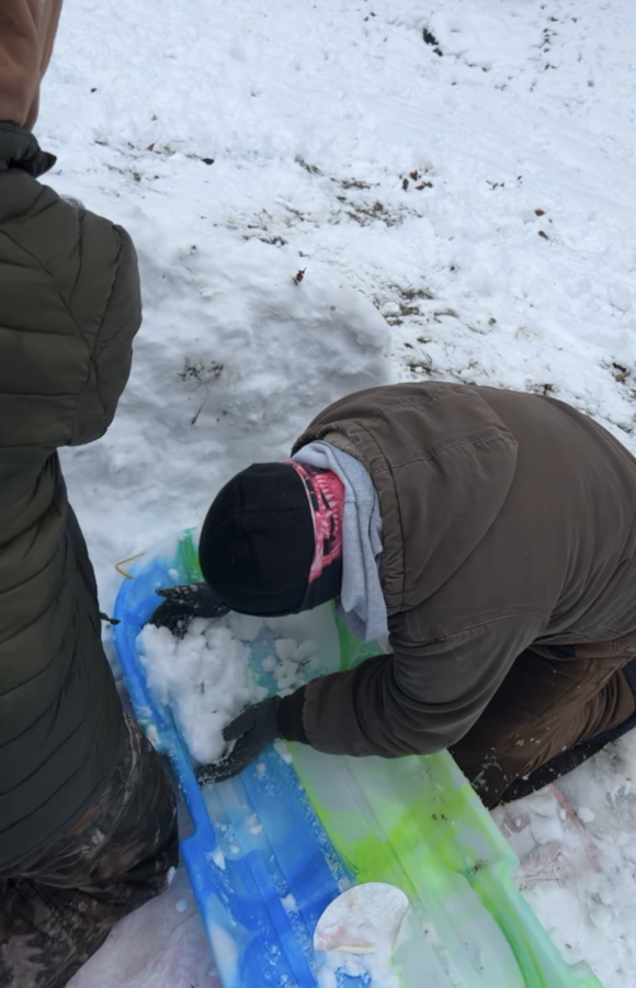 Alix Harris (11) building a snow fort on an AMI day. (photo taken by Jena Scaletty)