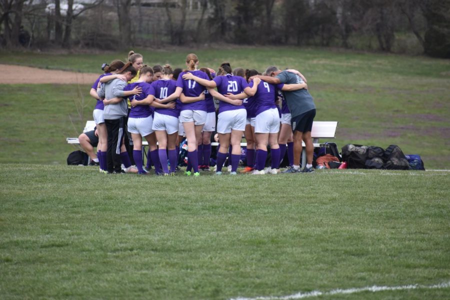 Krista Miller (left in grey) huddling with her team before the game. (photo taken by Brayde Smith)