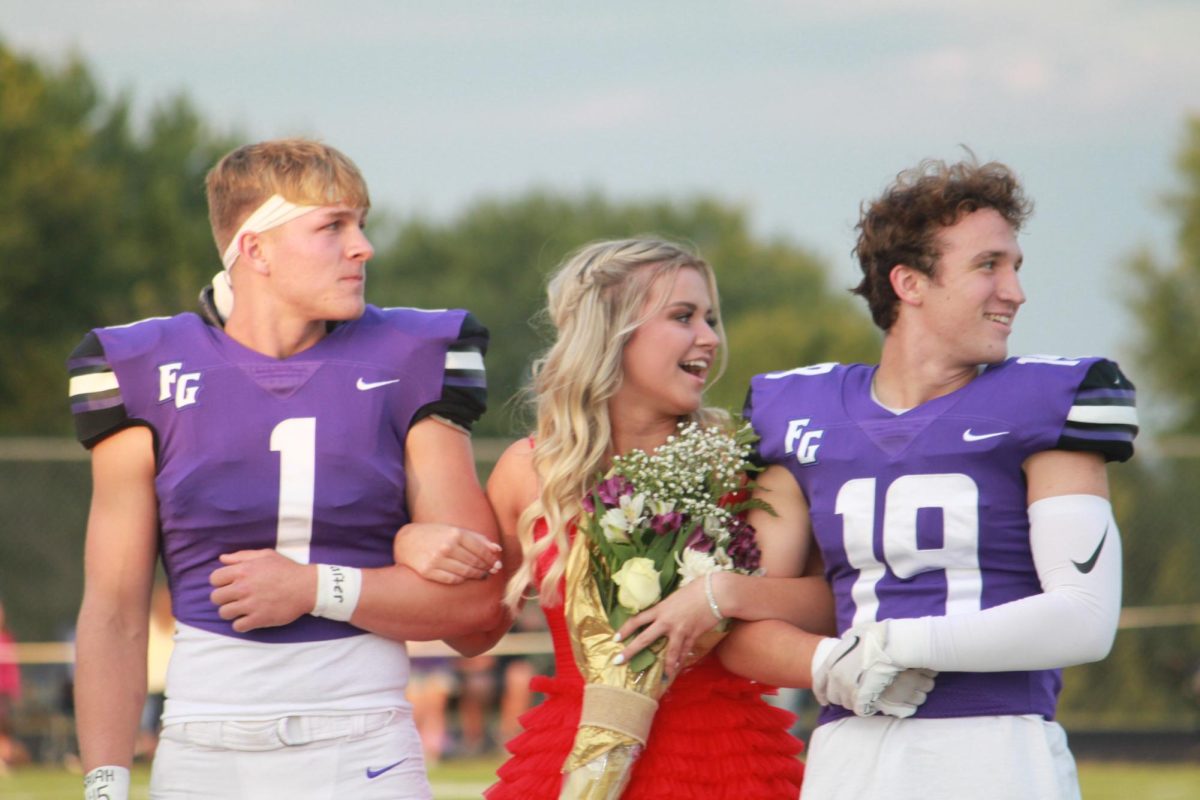 Kloe Hart, the 2022-2023 year queen after finding out she won. Escorted by Cooper Roy and Kurt Buckman (Photo taken by FGS Newspaper.)