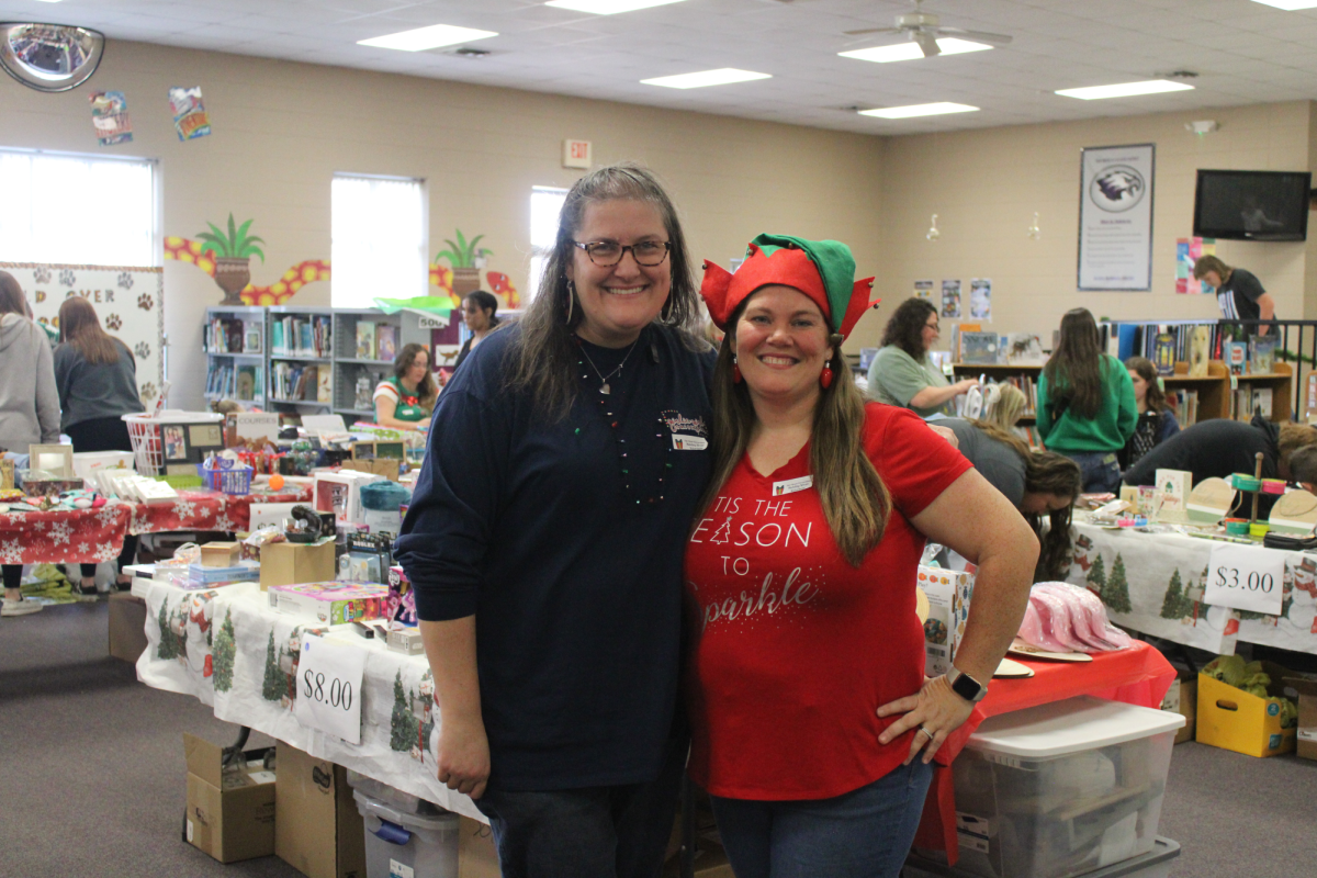 Karissa Jefferson (event co-chair) and Ashley Lederich (event chair) working at the PTO Holiday Shop