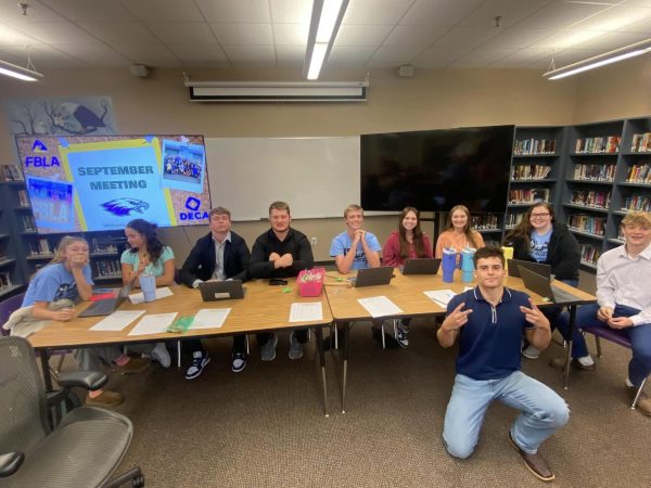 FBLA/DECA officers sitting together at a meeting. Left to right: Emaley Stallings, Gretta Morris, Jackson Martin, Oakland Wayne Morrison, Atticus Brandes, Addyson Nunley, Haylee Potter, Saylor Cowles, Carson Trussell, Dylan George