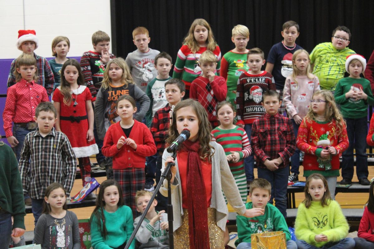 Fair Grove 3rd graders performing Crazy Carols, directed by Cindy Sparks. 

(Front Center, Speaker): Isabelle Mcculloch. 

(Row 1, Left to Right): Easton Lord, Izabella Faucett, Kevin Ives, Andrew Kissee, Aubrey Staley, Henry Dilley, Rhys Frazier, and Hudson Mcdanial. 

(Row 2, Left to Right): Beckam Smith, Miriya Cantrell, Quinnleigh Gumpolen, Beau Bates, Miller Hyde, Cameron Salmons, Austen Wood, and Derek Kisling.

(Row 3, Left to Right): Carter Winder, Mahala Calton, Jarrett Hollingsworth, Kaitlyn Mauldin, Timothy Taylor, and Emmalaina Collishaw.

(Row 4, Left to Right): Kinsley Johnson, Maelynn Calton, Kameryn Coker, Charlie Mcmains, and Paisley Wood.