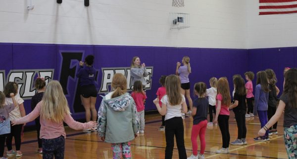 Elementary Students Throwing Pom Poms